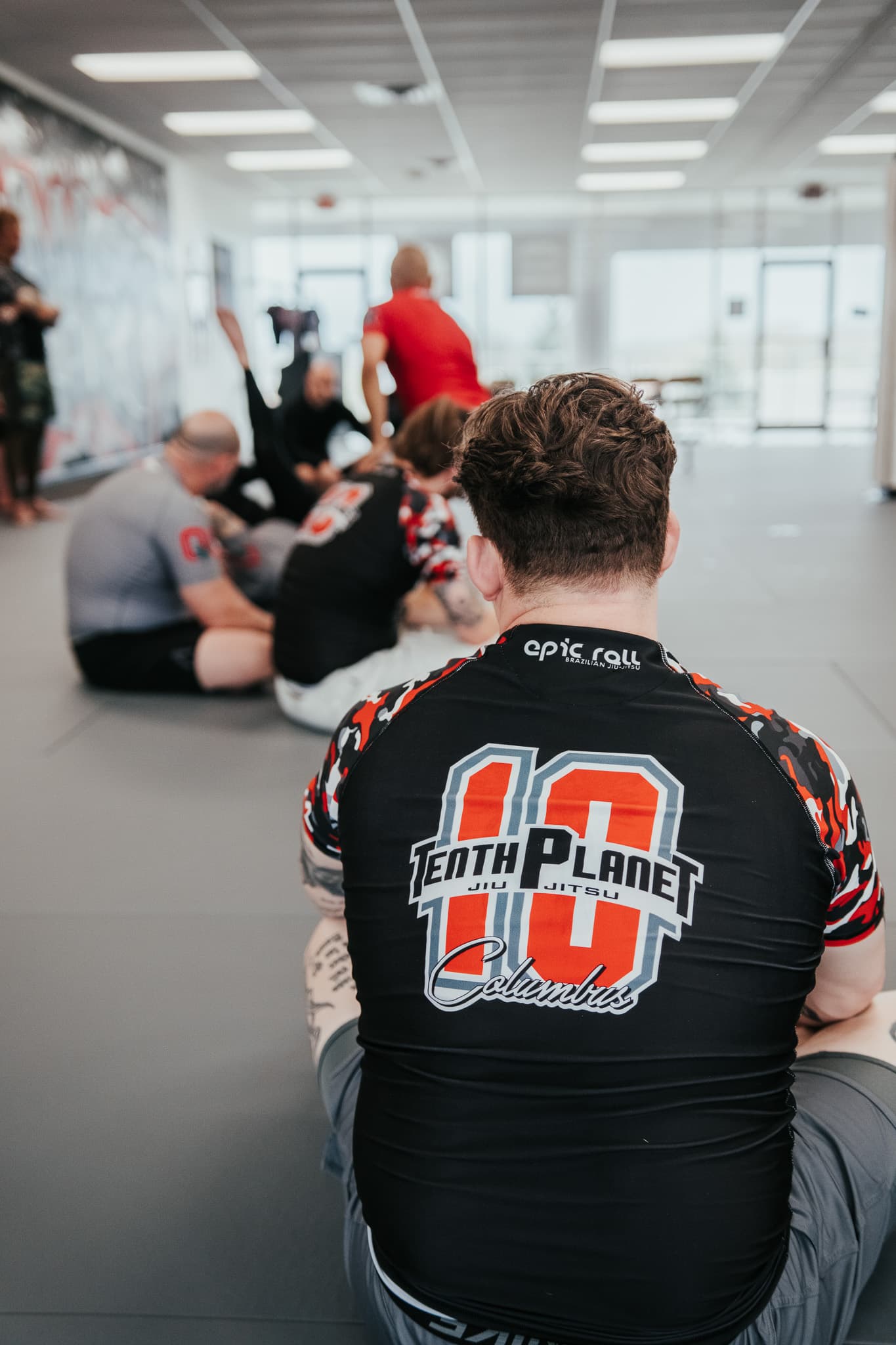 10th Planet Columbus team rashguard — student on the mats with the 10P Columbus back logo visible.