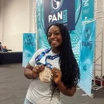 A 10th Planet Columbus team member holding up her medal at a Jiu-Jitsu tournament