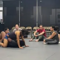 Women practicing ground positions together during a group Jiu-Jitsu session