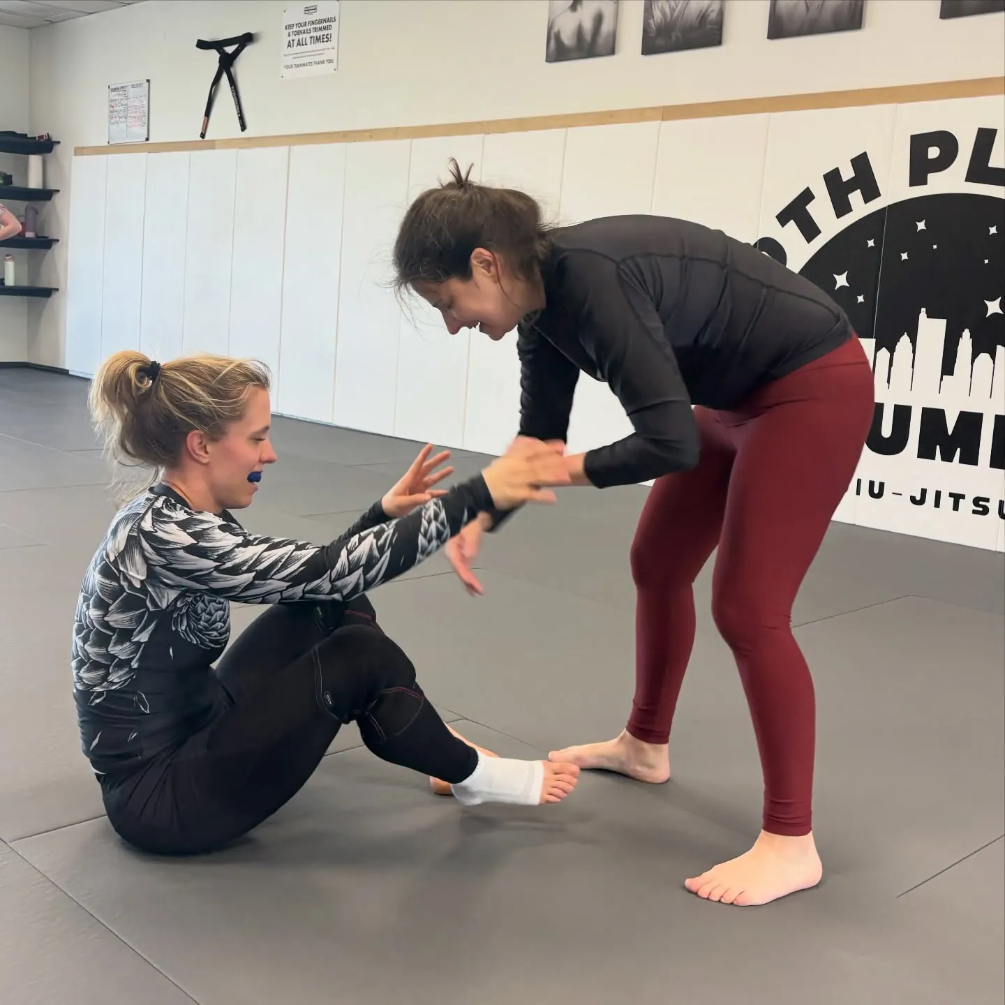 Two women drilling a standing guard-pass entry during the women’s no-gi Jiu-Jitsu class at 10th Planet Columbus